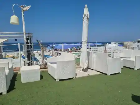 Lounge seating with stage truss and sea view at Sea Public in Aspra, Italy — salsa, bachata venue in Aspra