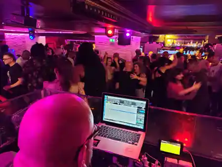 Crowded dance floor with DJ at Vendôme Club, Paris bachata and salsa night