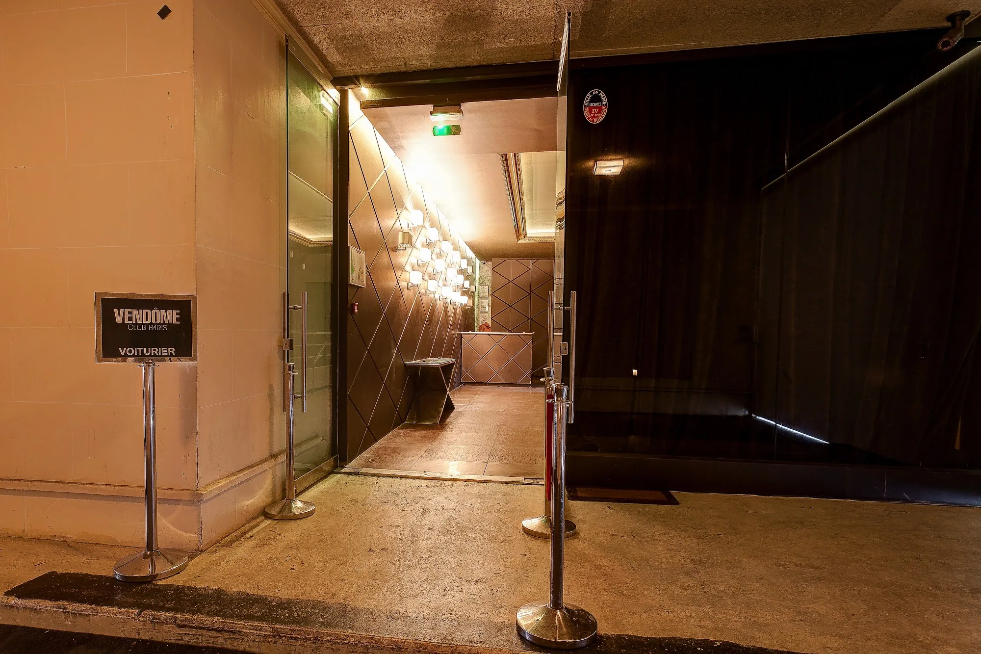 Branded entrance of Vendôme Club Paris with illuminated corridor