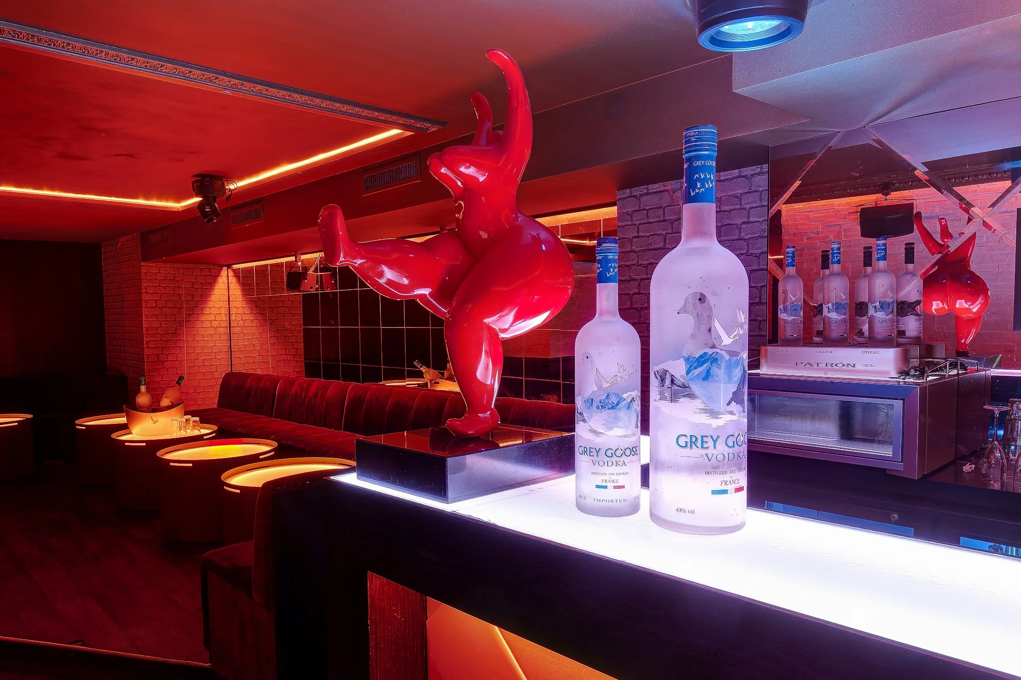 Bar and lounge interior with red lighting at Vendôme Club, Paris