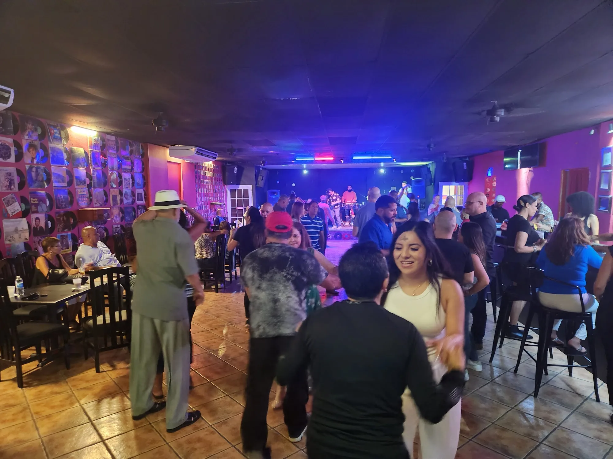 Dancers on the floor at Música Bar Lounge San Juan with live band on stage