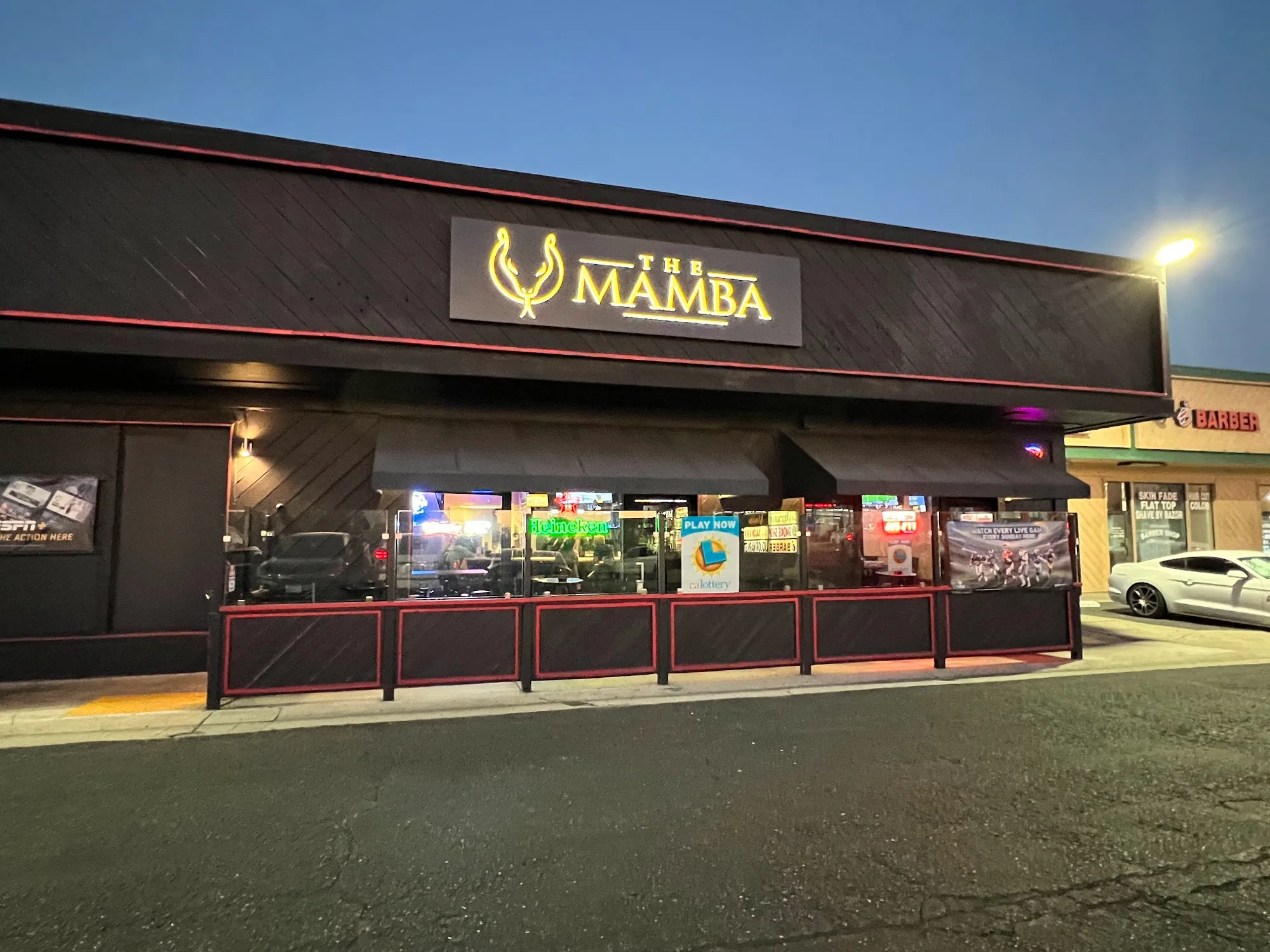 The Mamba illuminated sign at night at the Huntington Beach sports bar and grill