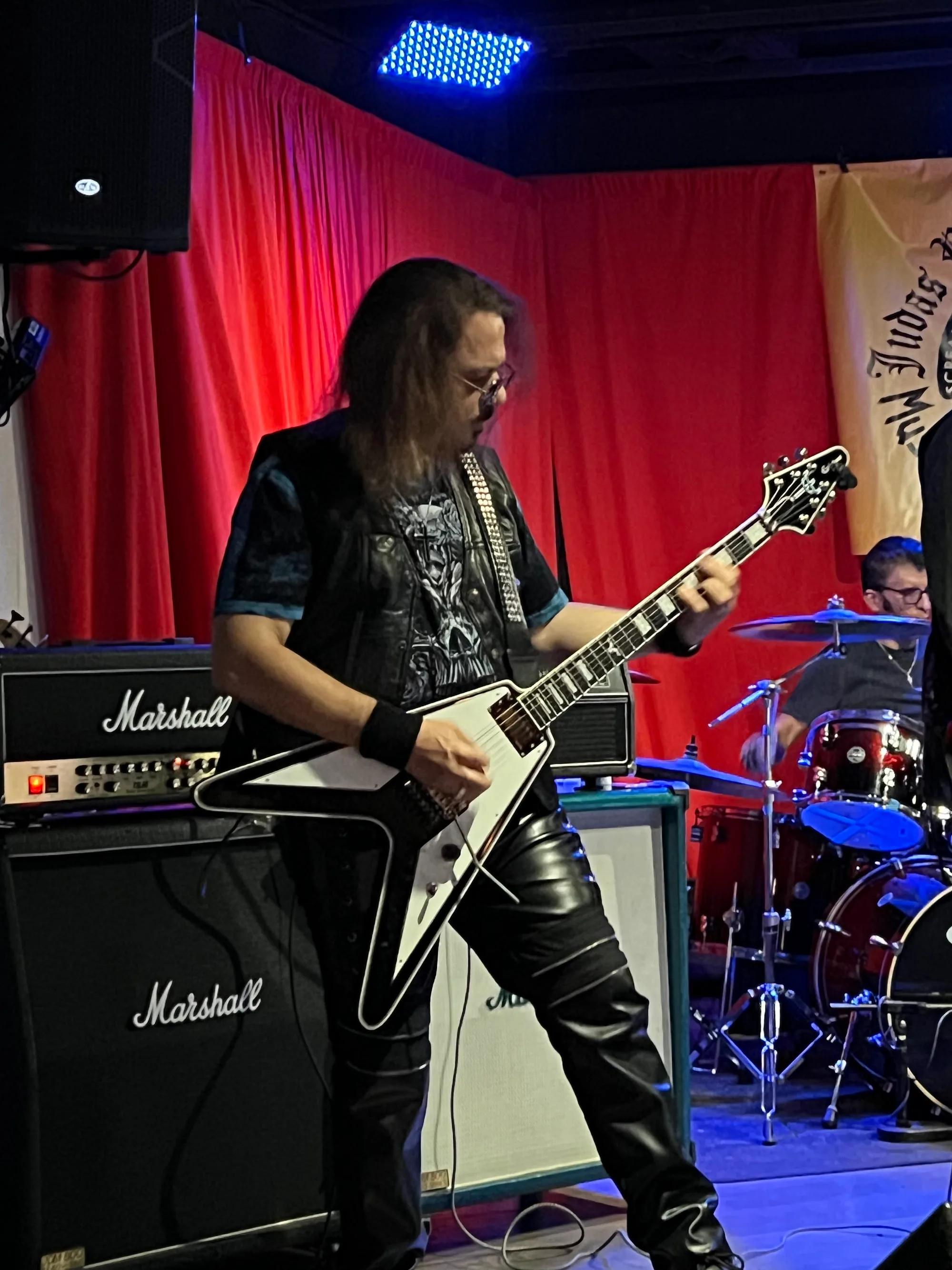 Guitarist performing live on the red-lit stage at The Mamba in Huntington Beach