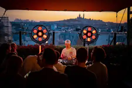 DJ set with crowd at sunset rooftop party at Generator Hotel — salsa, bachata venue in Washington, D.C.
