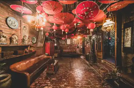 Eclectic interior with red Chinese umbrellas and lanterns at La Favela Bali — salsa, bachata venue in Bali