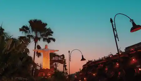 Christ the Redeemer replica at sunset in La Favela Bali's Rio-themed garden — salsa, bachata venue in Bali