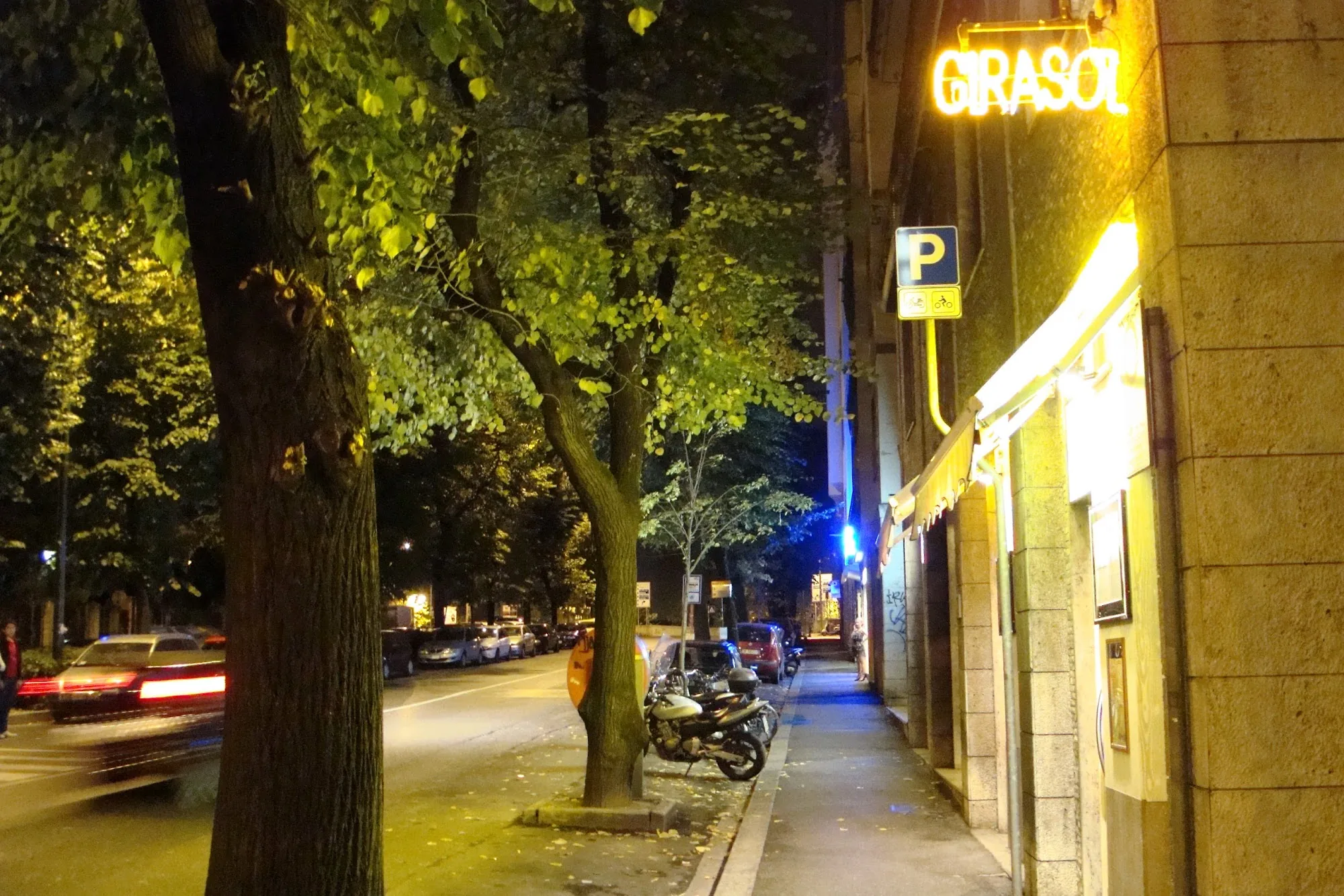 Girasol venue exterior with illuminated sign at night in Florence Italy