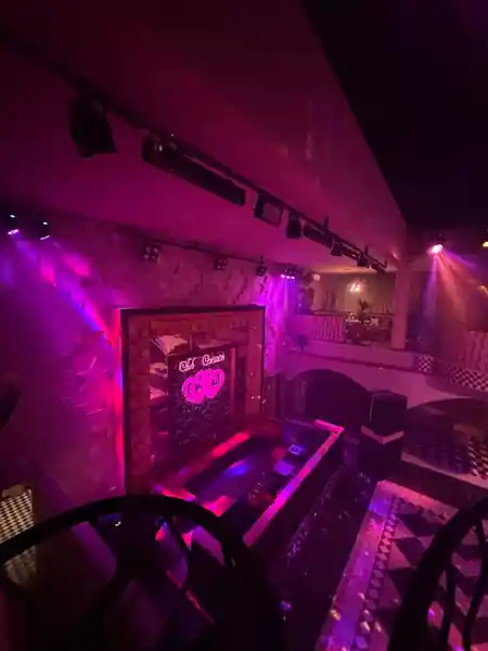 Balcony view of Club Corazon Bali's DJ booth and dance floor with club lighting and mirror ball in Bali — bachata venue in Bali