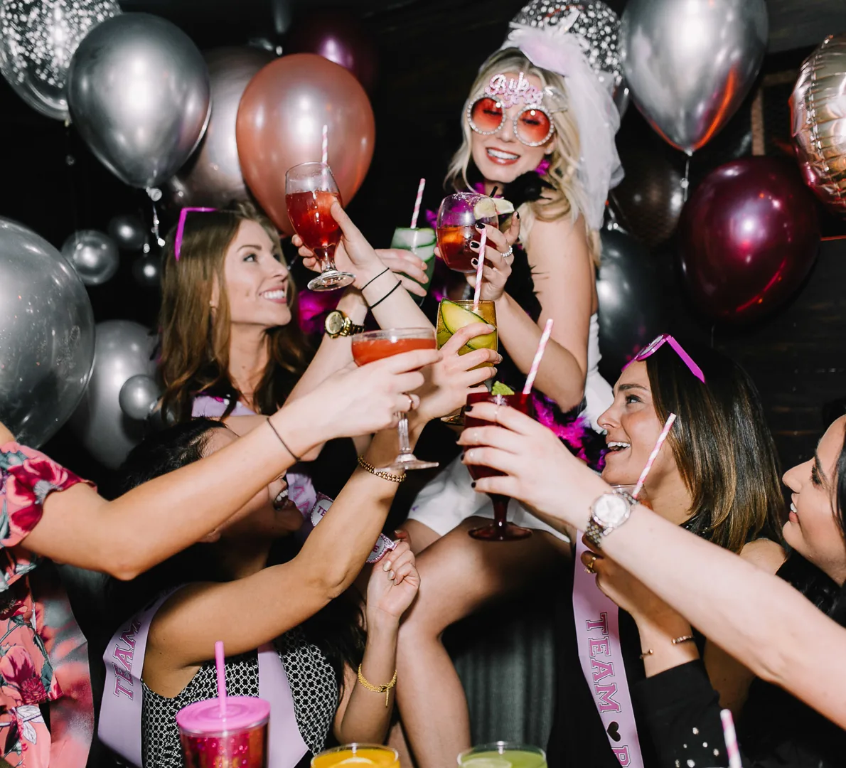 Guests celebrating with drinks and balloons at a party inside K. Pacho New York