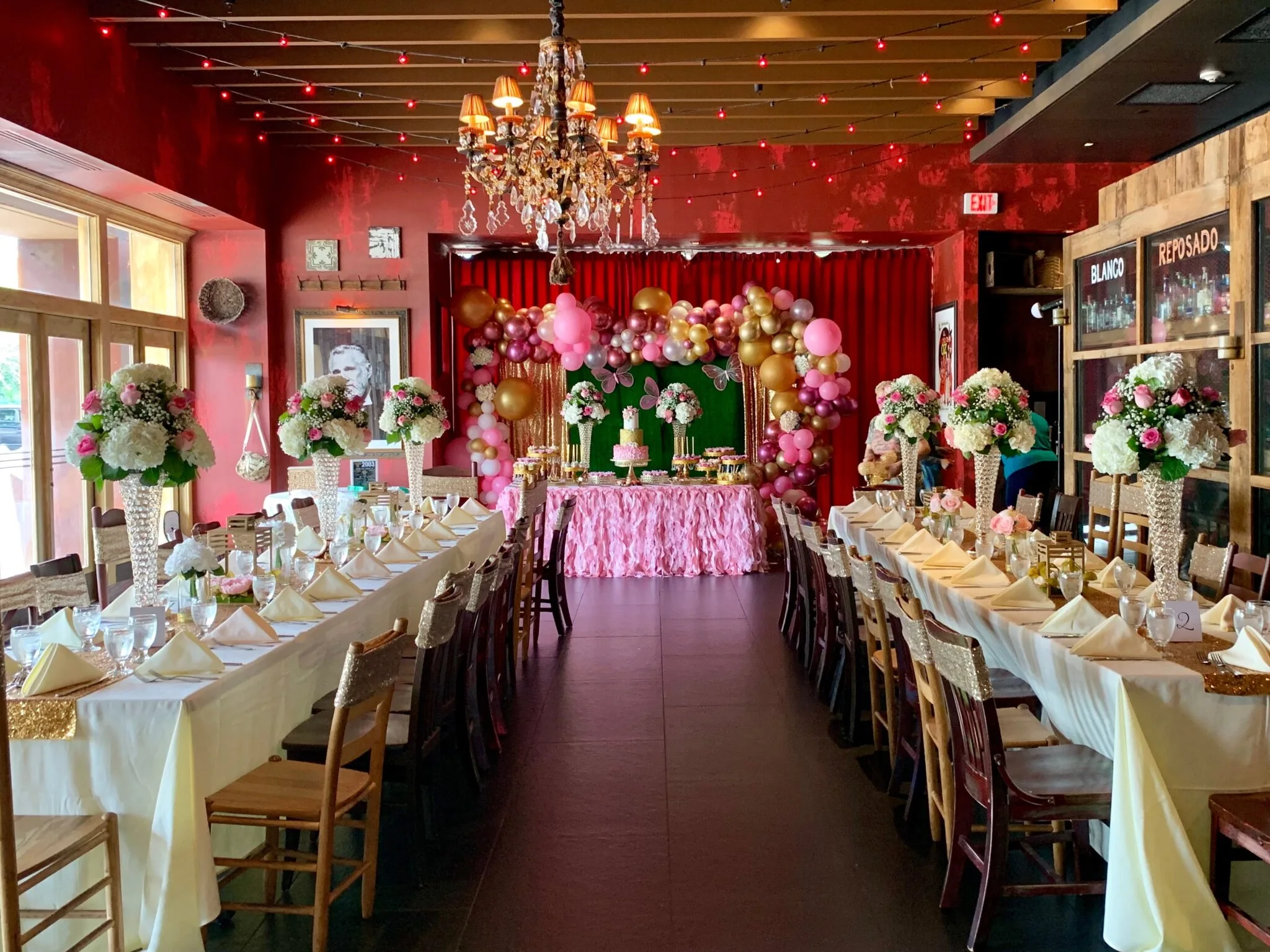 Decorated dining hall with chandeliers and floral arrangements at K. Pacho New York