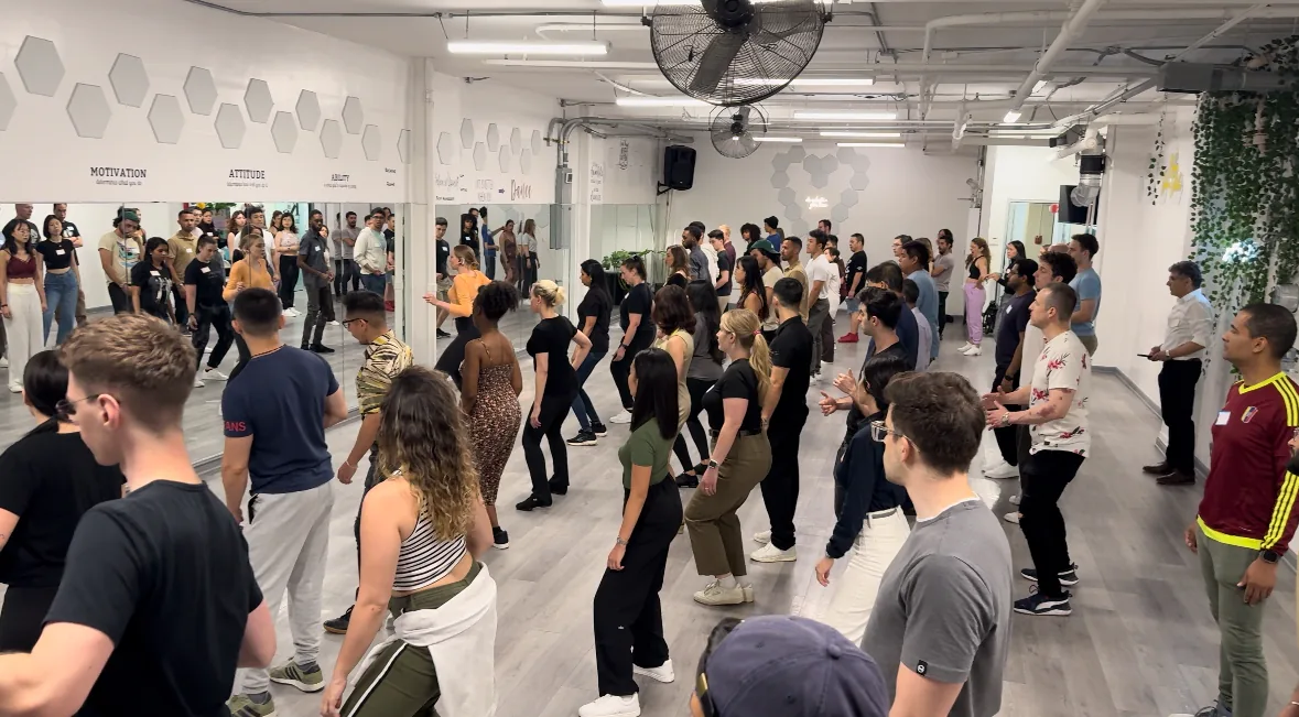 Group dance class with dozens of students on the studio floor at KTown Dance Studio in New York