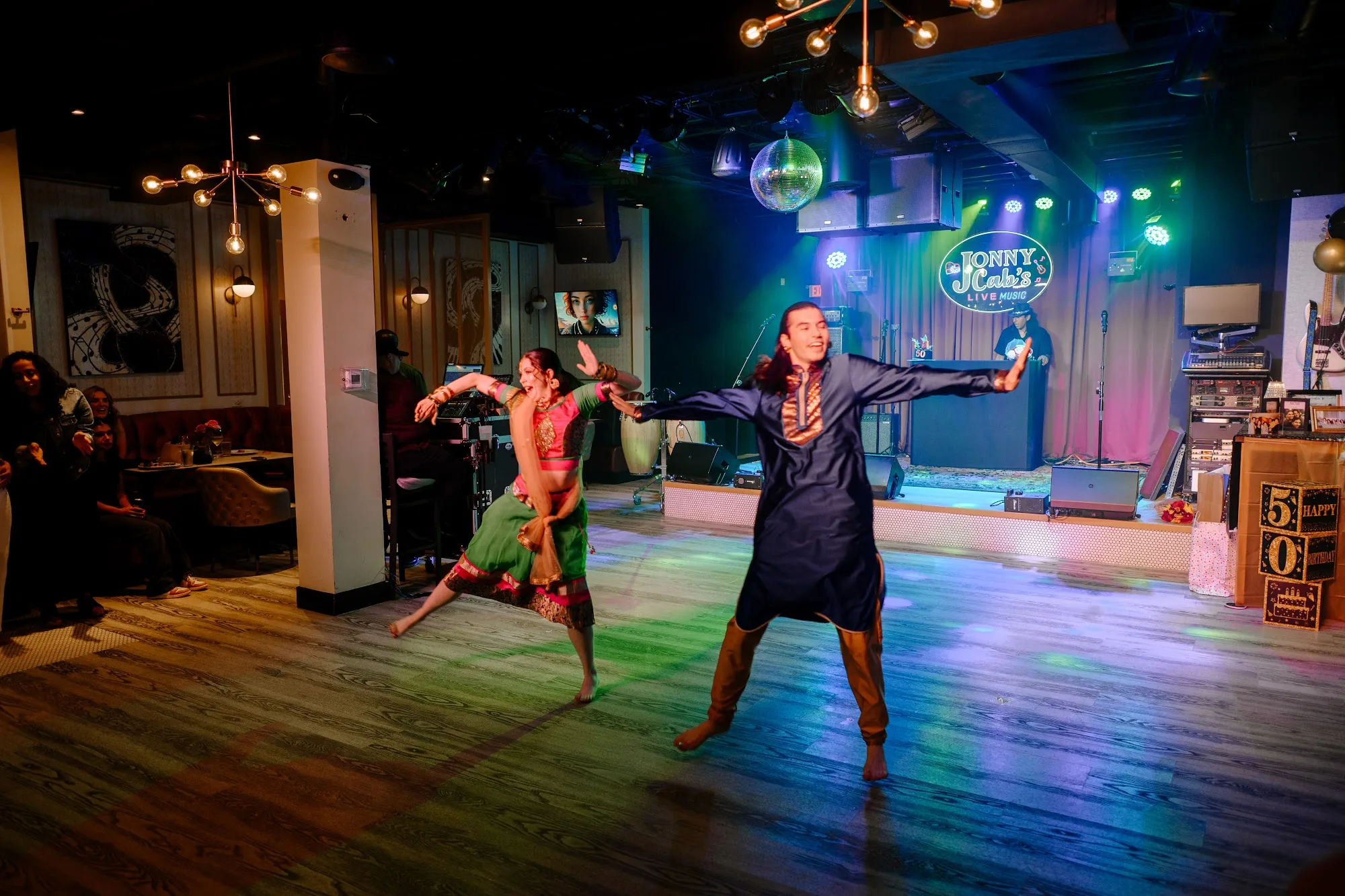 Dancers performing on the Jonny Cab's dance floor under club lights