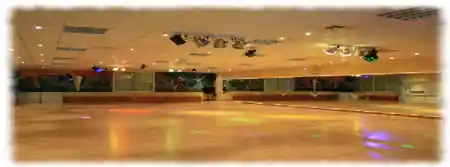 Large dance hall with colored stage lighting at École de Danse Mansouri Dijon France — bachata, salsa, kizomba venue in Dijon