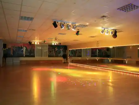 Dance floor with colored lights and dance murals at École de Danse Mansouri Dijon — bachata, salsa, kizomba venue in Dijon