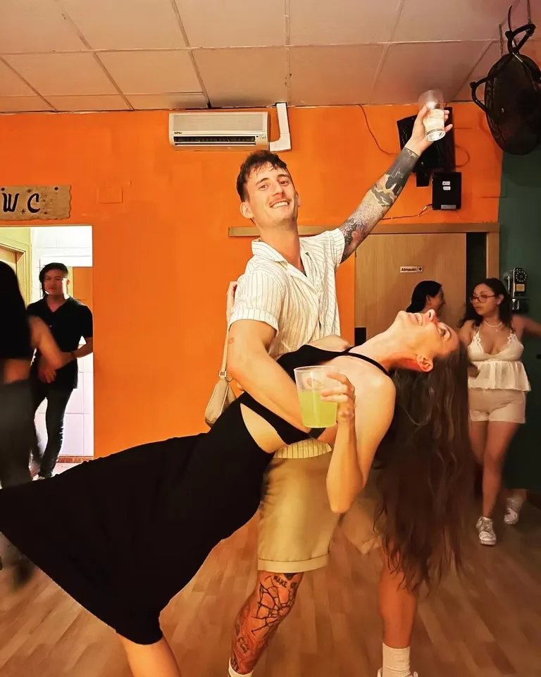Couple in a salsa dip on the wooden dance floor at Miky House Valencia