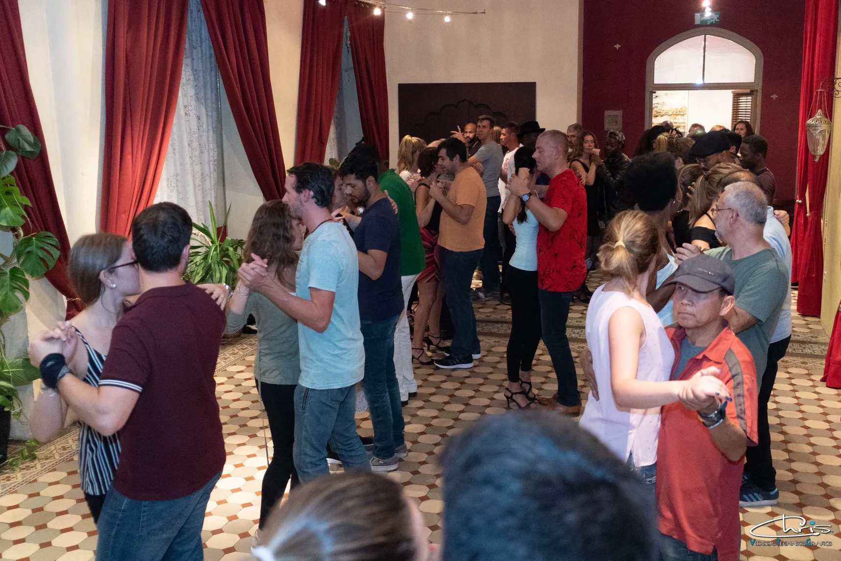 O'Dance Brussels — Latin social dance night with partners dancing in ornate hall with red drapes