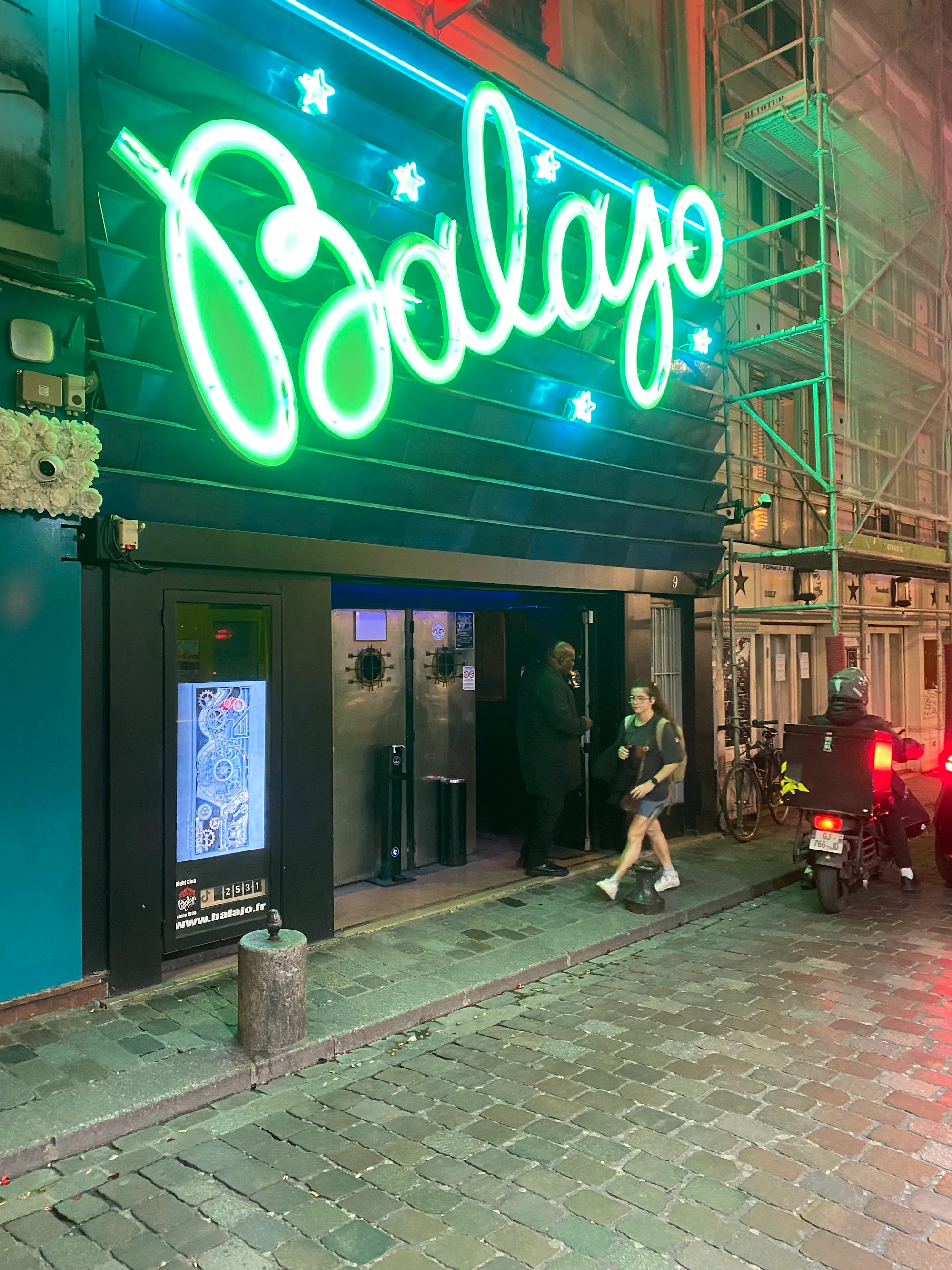 Balajo neon-lit entrance sign at night on a Paris street