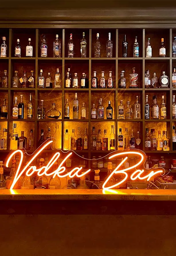 Vodka Bar neon sign glowing over the bottle wall at Vodka Temple in Melbourne