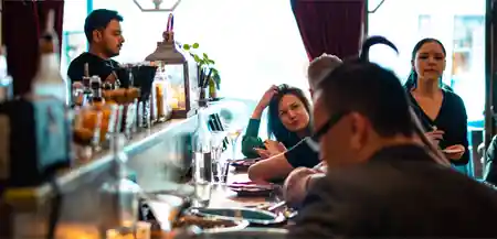 Guests and bartender at the lively bar inside Vodka Temple in Melbourne, bachata venue in Melbourne