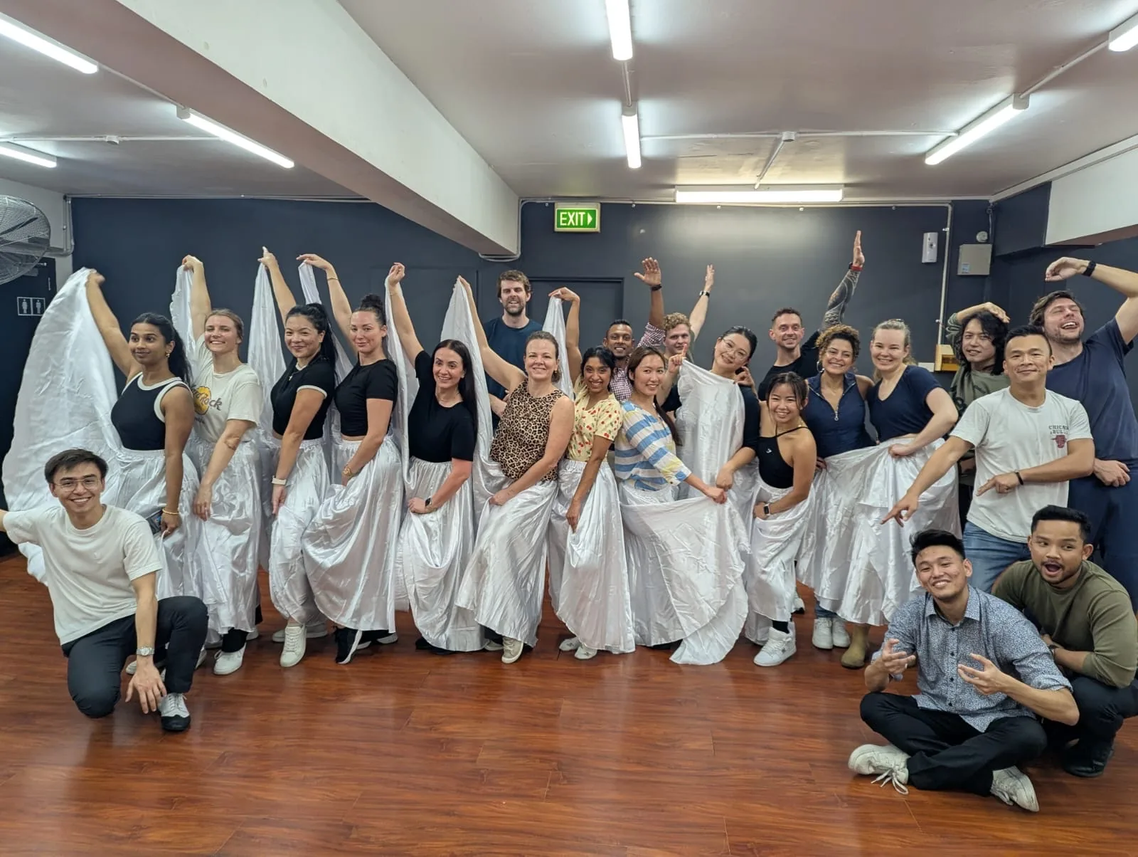 Group of Brazilian Zouk dancers posing on the wooden dance floor at ALMA studio, Sydney