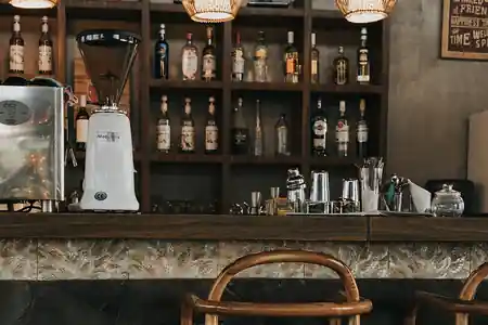Bar with back-bar bottles and bentwood stools at MaxOneHotel Ubud, Bali — zouk venue in Bali