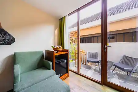 Lounge seating area with garden view inside MaxOneHotel Ubud, Bali — zouk venue in Bali