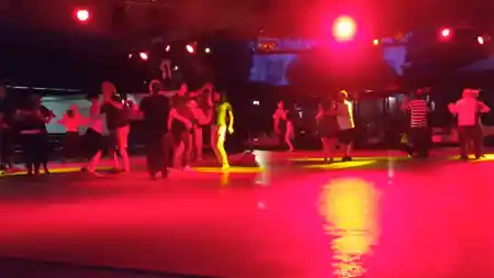 Penelope Beach Torino — dancers on outdoor dance floor under stage lighting at night — salsa, bachata venue in Torino