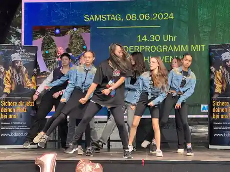 Broadway Dance School hip-hop performance on stage with BDS banner — salsa, bachata venue in Dresden