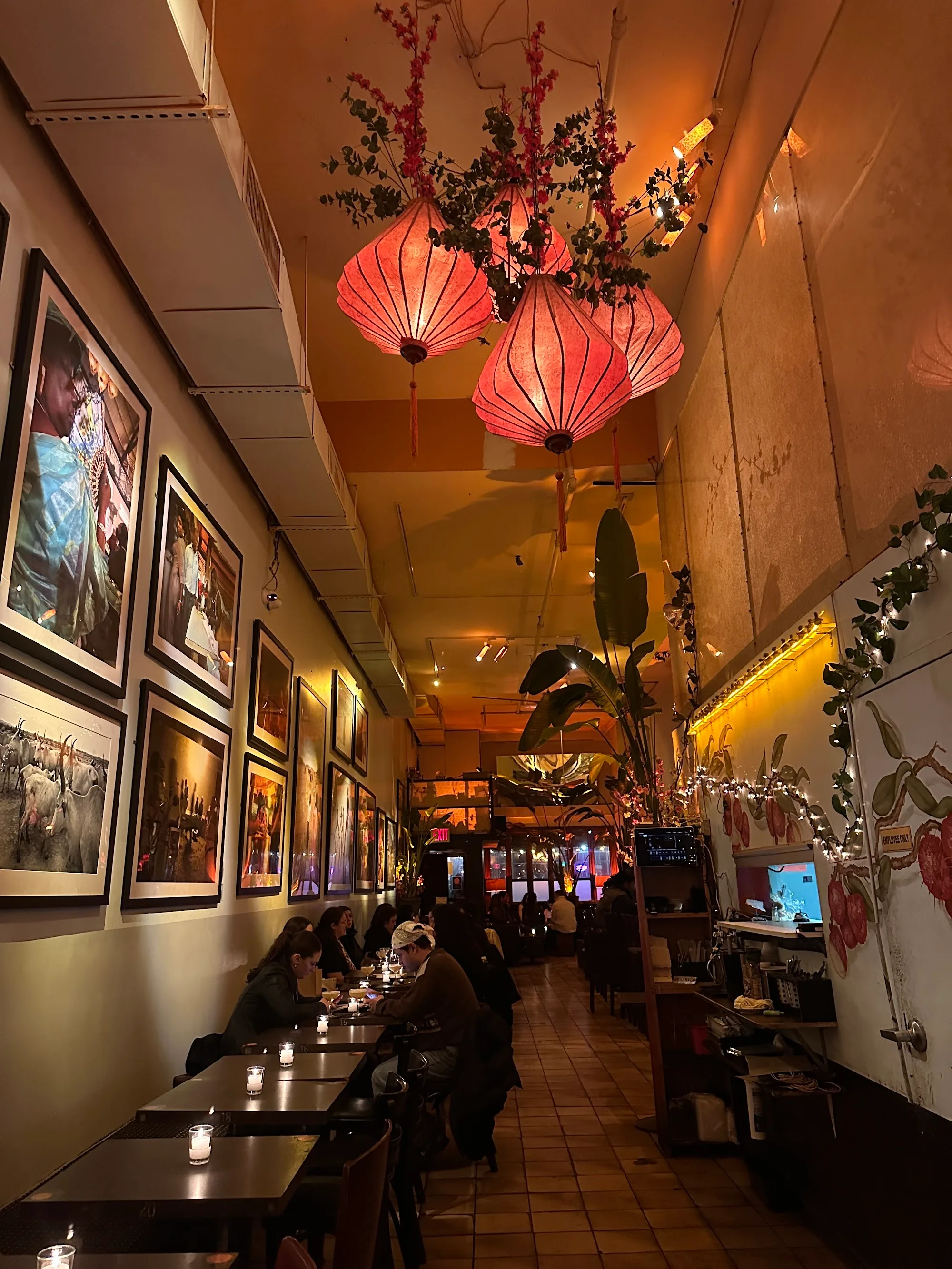 Cozy lounge interior with hanging lanterns at Verlaine bar in New York