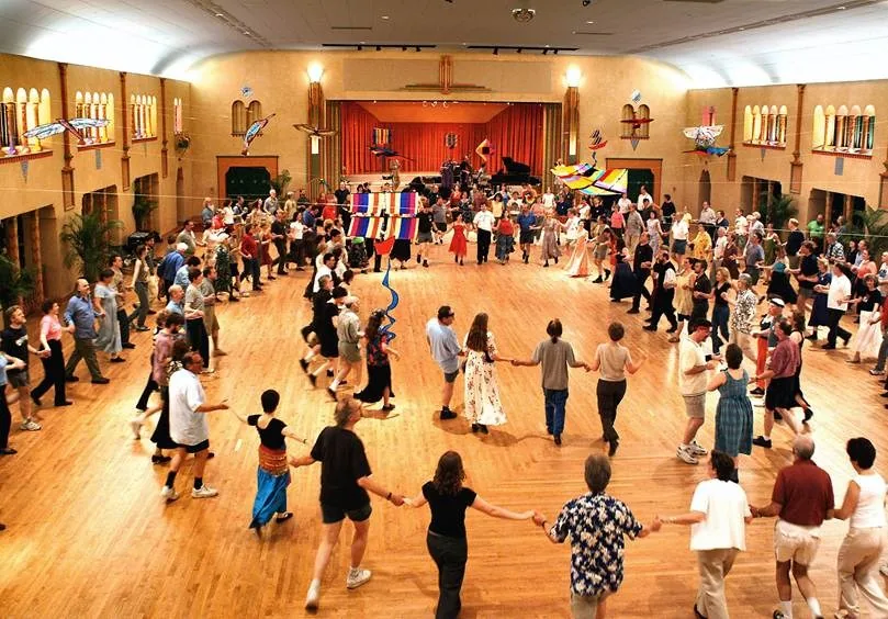 Aerial view of a large group dance circle on the wooden ballroom floor at Glen Echo Park in Washington D.C.