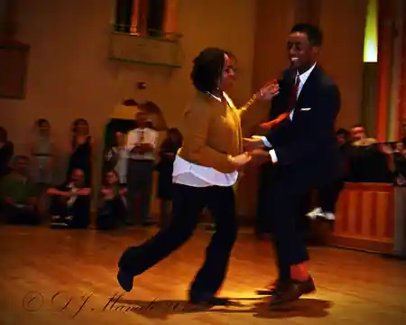Dance couple performing on the wooden ballroom floor at Glen Echo Park in Washington D.C. with audience watching — zouk venue in Washington, D.C.