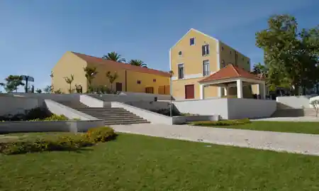 Exterior of the yellow Casa Amarela cultural centre venue in Almada, Portugal, bachata venue in Almada