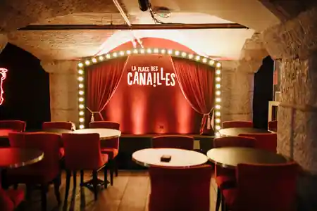 Stage with La Place des Canailles illuminated marquee sign, empty seating area in front — bachata, salsa venue in Marseille