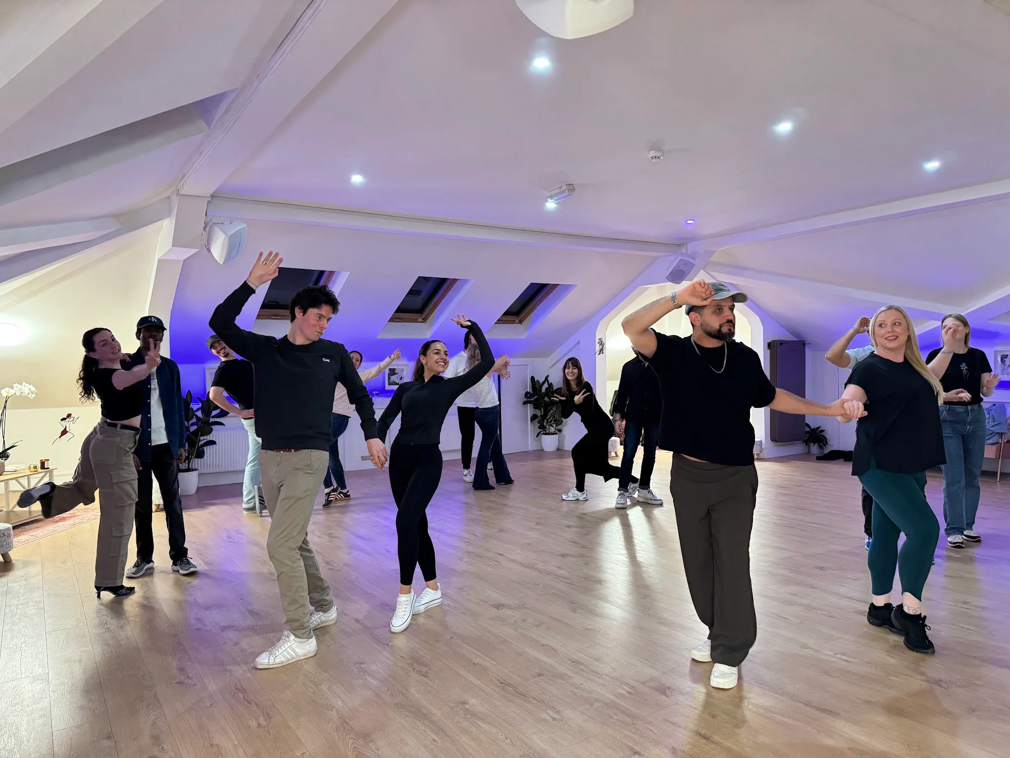 Beyond Dance Dublin class in progress with multiple couples dancing under blue lights
