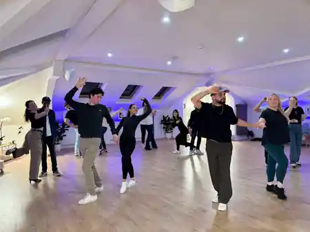 Beyond Dance Dublin class in progress with multiple couples dancing under blue lights — bachata, kizomba venue in Dublin