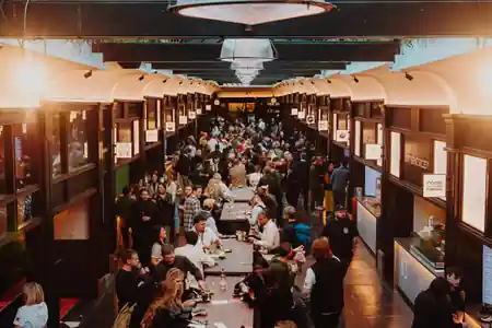 Crowd dining and socialising inside Boxhall City food hall in London — bachata, salsa venue in London