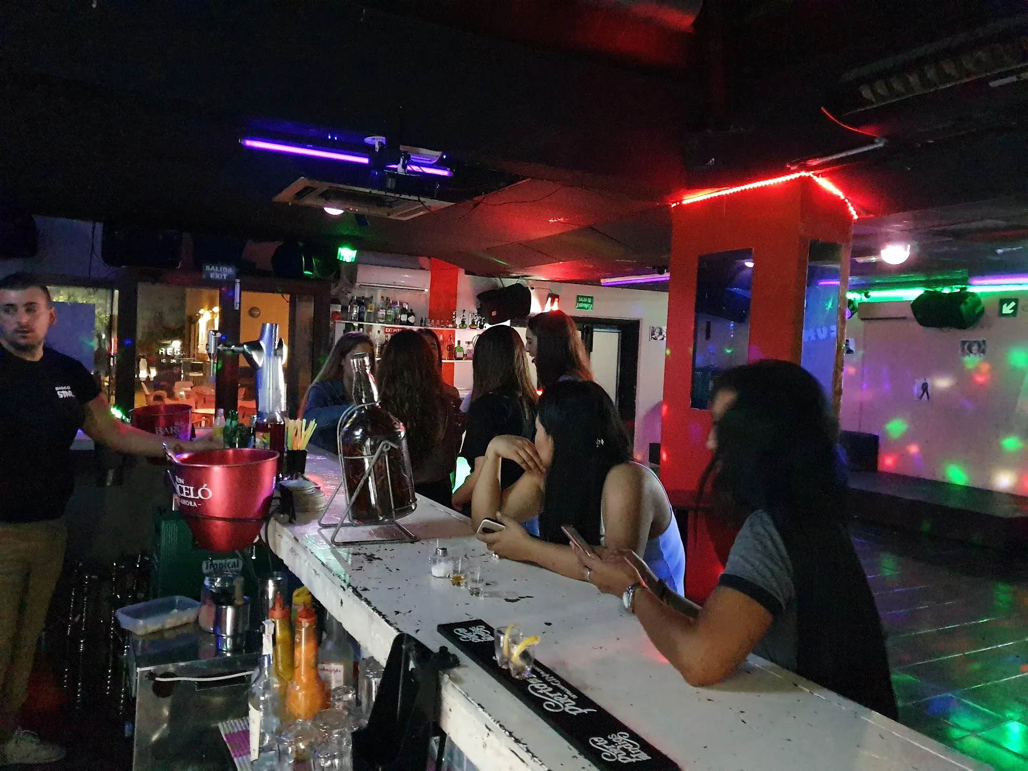 Bar and dance floor with disco lights at Disco Star Corralejo nightclub — bachata venue in Corralejo