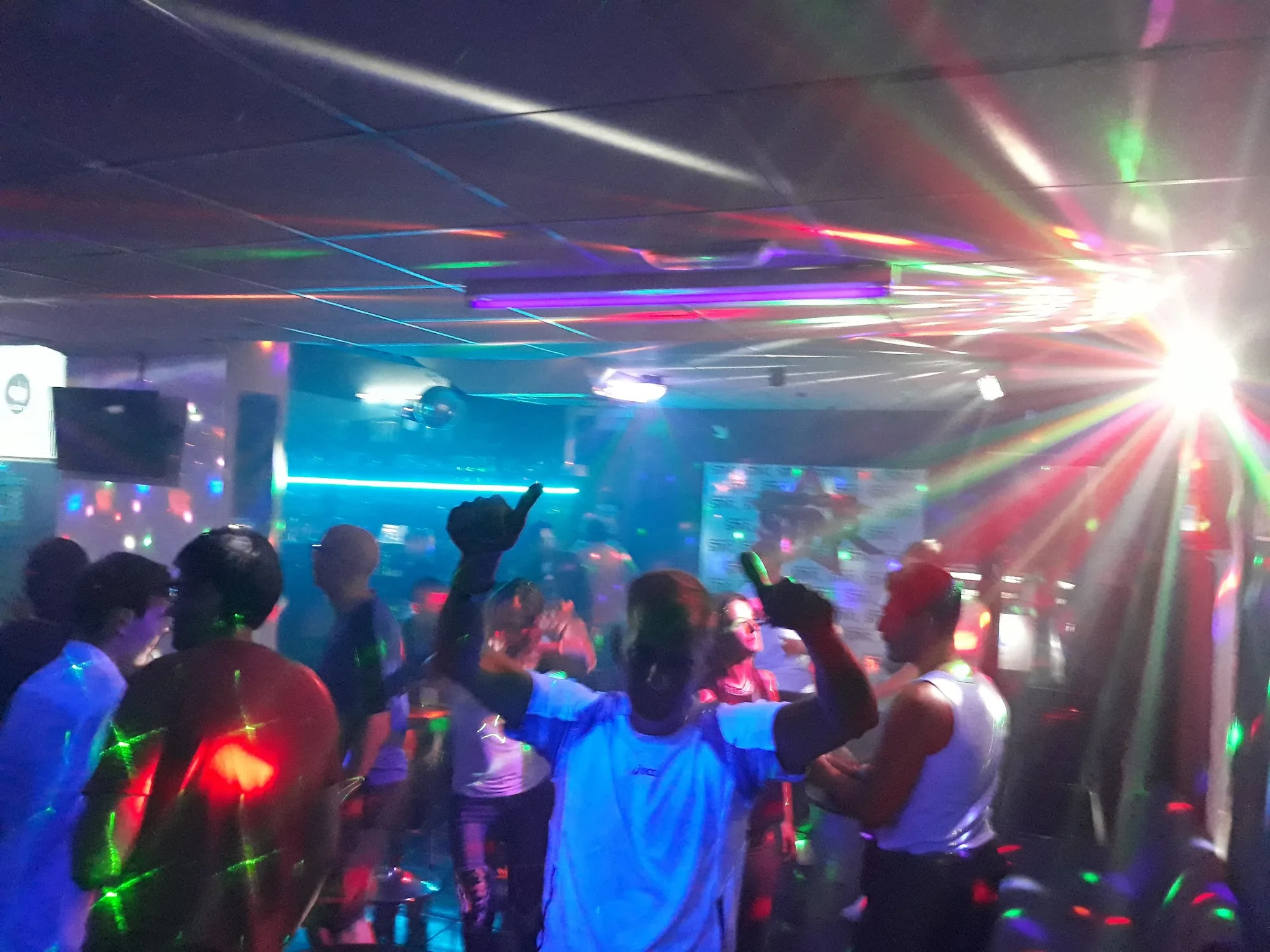 Dancers under multicoloured disco beams at Disco Star Corralejo nightclub in Fuerteventura