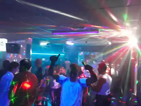 Dancers under multicoloured disco beams at Disco Star Corralejo nightclub in Fuerteventura — bachata venue in Corralejo