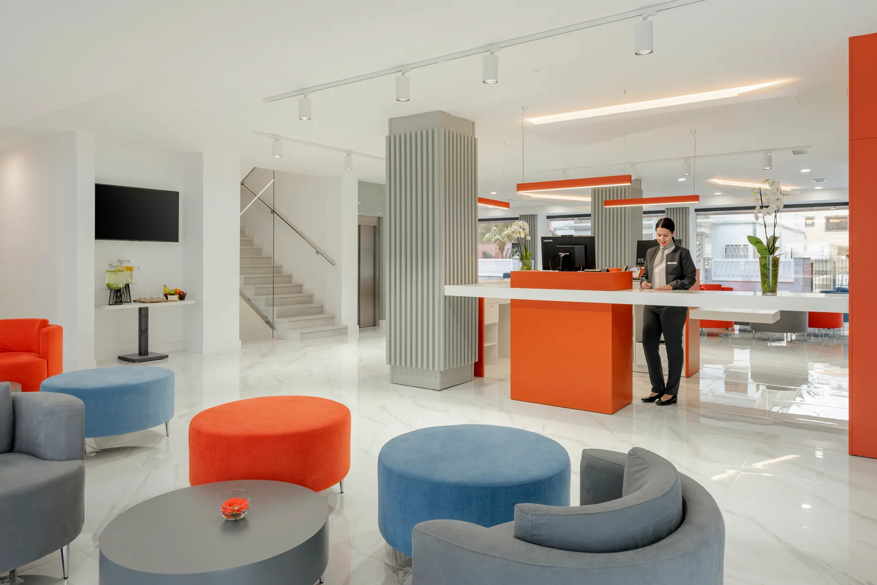 Occidental Las Palmas Hotel lobby in Las Palmas de Gran Canaria — modern reception with orange accents and lounge seating