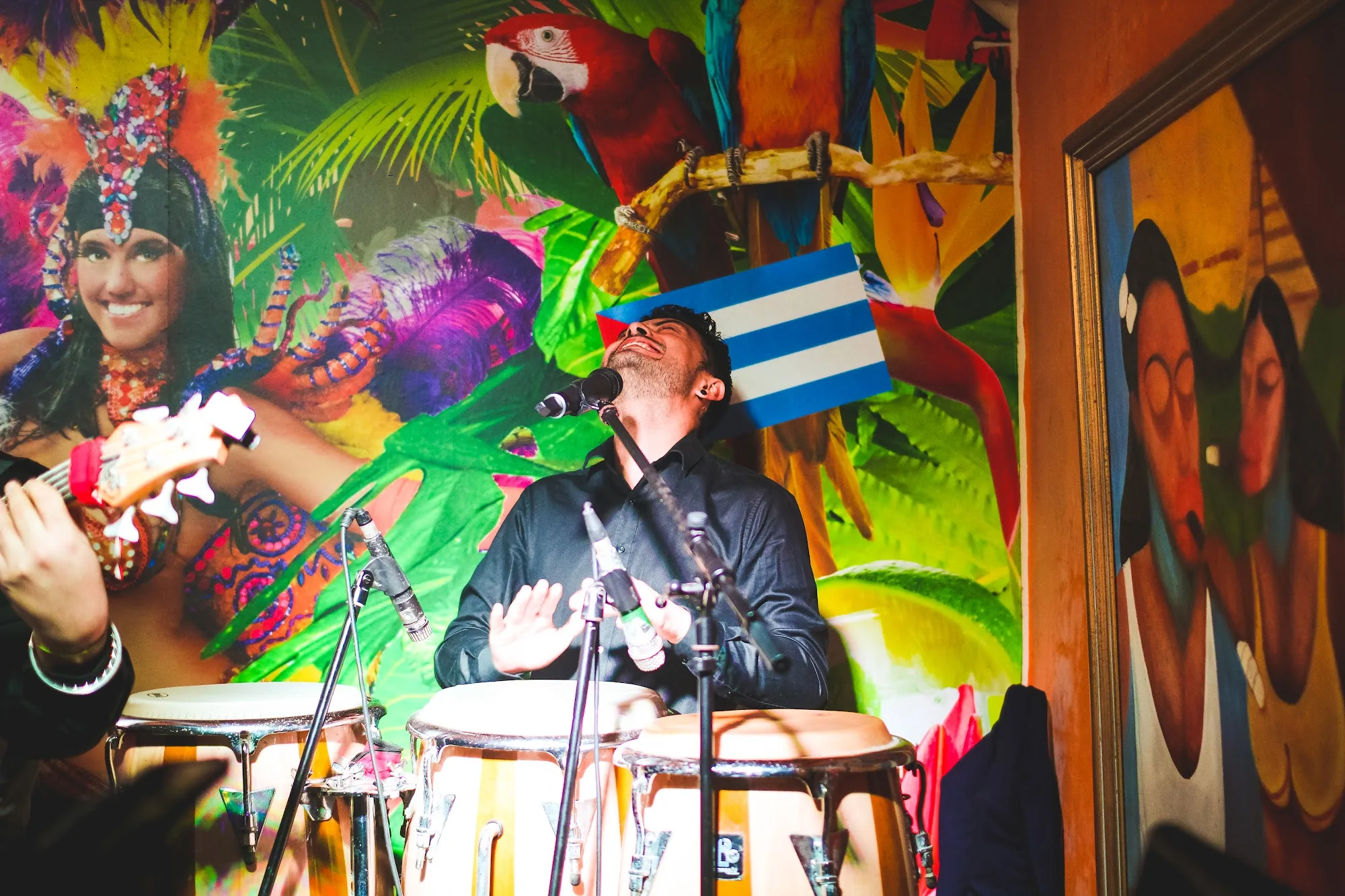 Live conga musician performing at Cuba Libre Singapore with Cuban murals