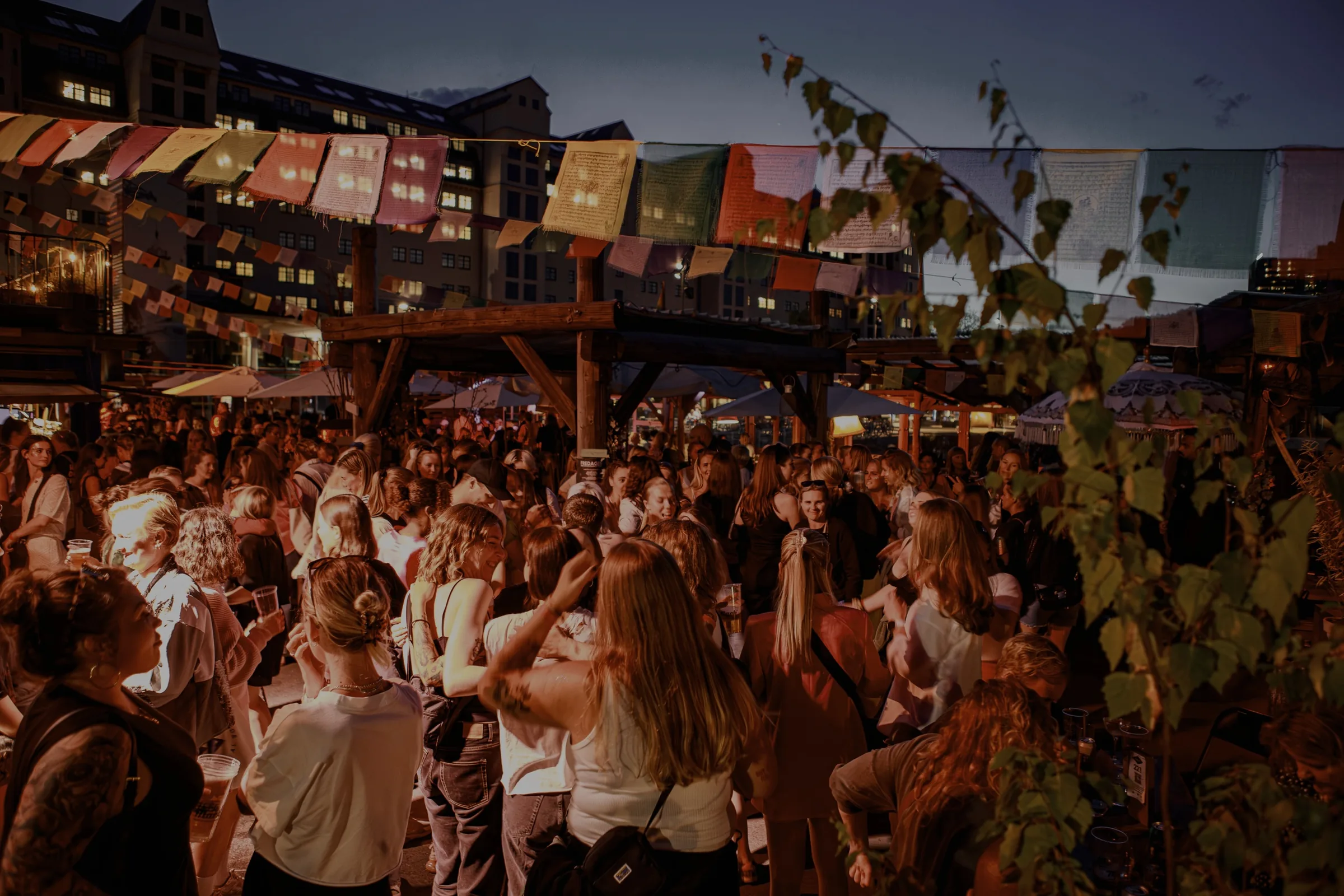 Evening party crowd under festival flags at SALT Art and Music on the Oslo waterfront, salsa, bachata venue in Oslo