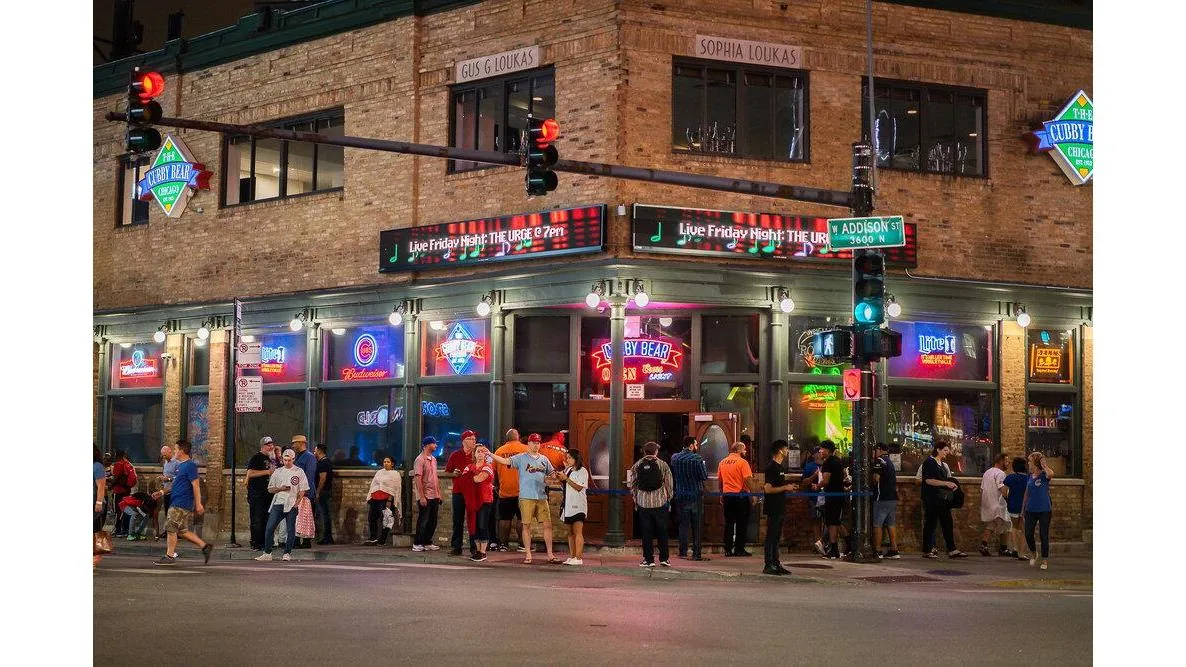 Nighttime exterior of The Cubby Bear on the Addison Street corner with neon signage and a crowd outside