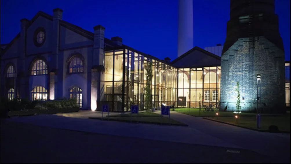 Kedelhallen venue exterior at night in Copenhagen showing the illuminated converted industrial building