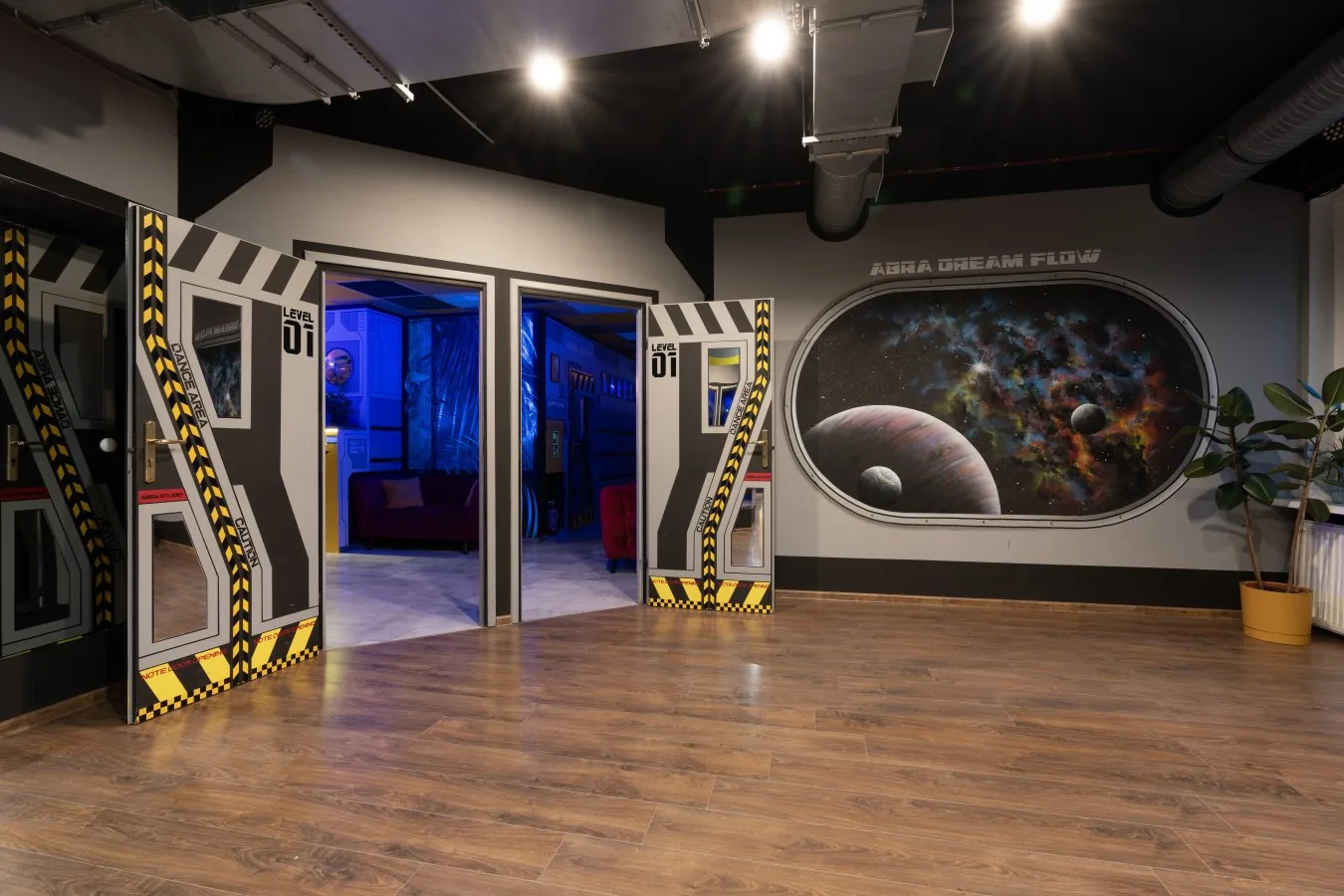 Abra Studio dance room entrance with Abra Dream Flow space-themed decor and wooden dance floor in Warsaw