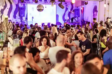 Busy dance night at Juju's Bar and Stage in London with couples on the dance floor under disco ball lighting — salsa venue in London