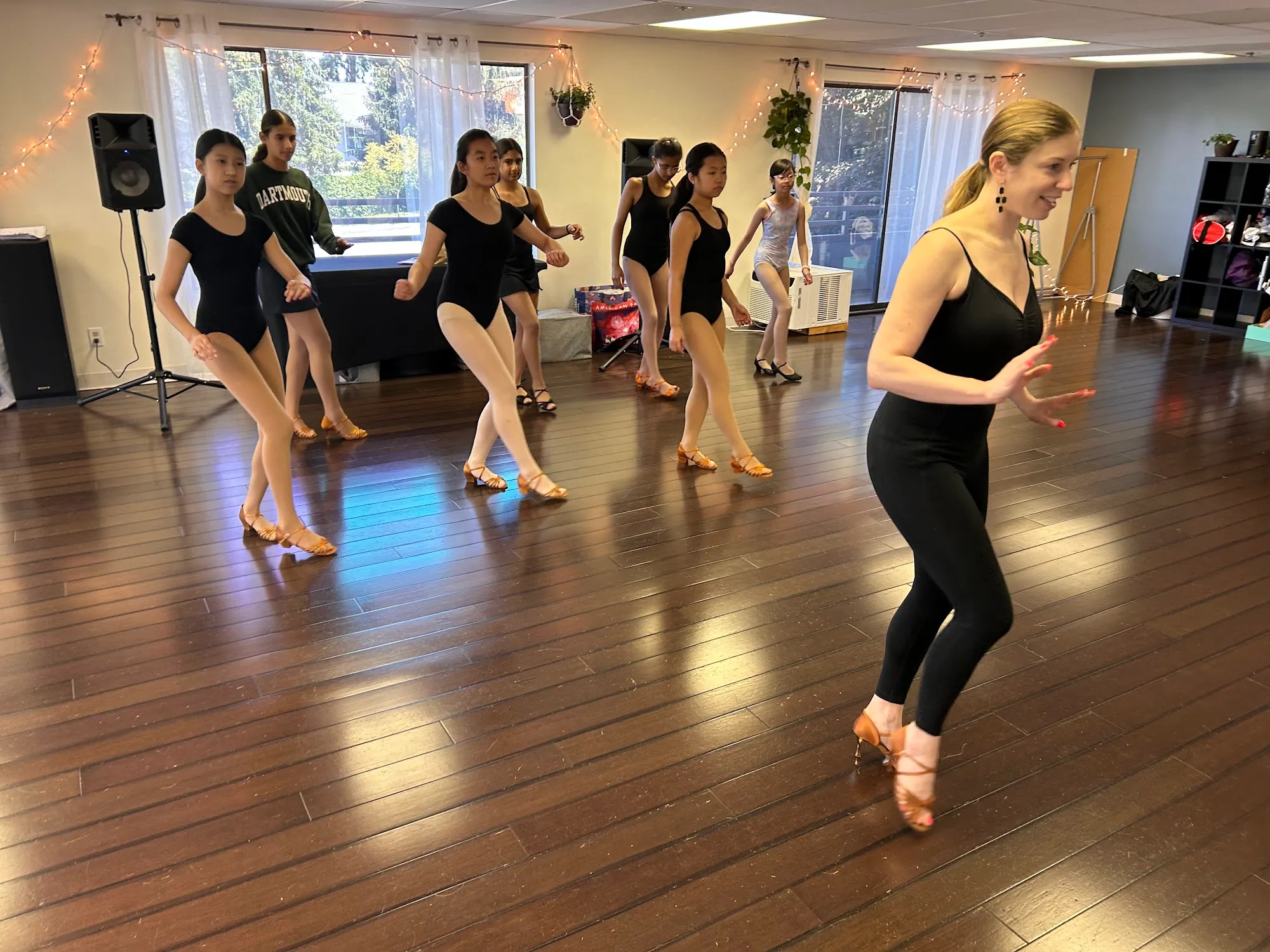 Dancers practicing on the wood studio floor at Bravo Dance School, salsa, bachata venue in Seattle