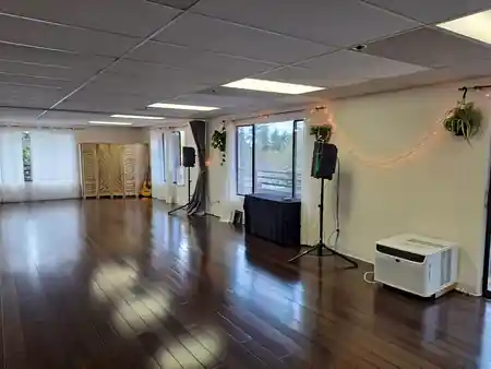 Interior of the Bravo Dance School studio with wood floor, mirrors and string lights, salsa, bachata venue in Seattle