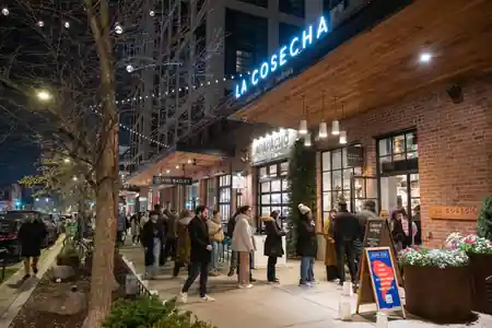 La Cosecha food hall exterior with branded signage at night in Washington D.C. — salsa, bachata venue in Washington, D.C.