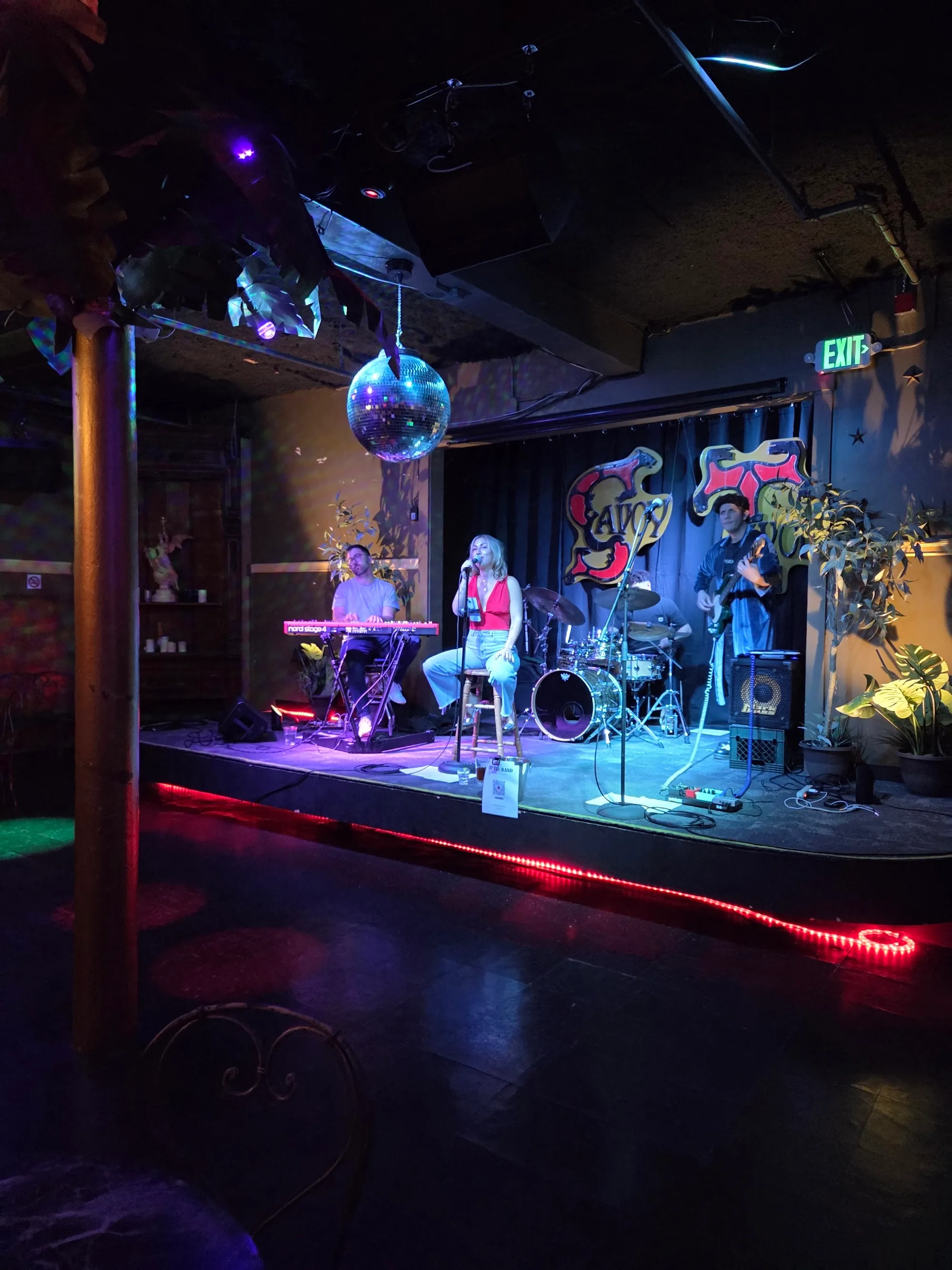 Live band performing on stage with disco ball and dance floor at Savoy Tivoli in San Francisco